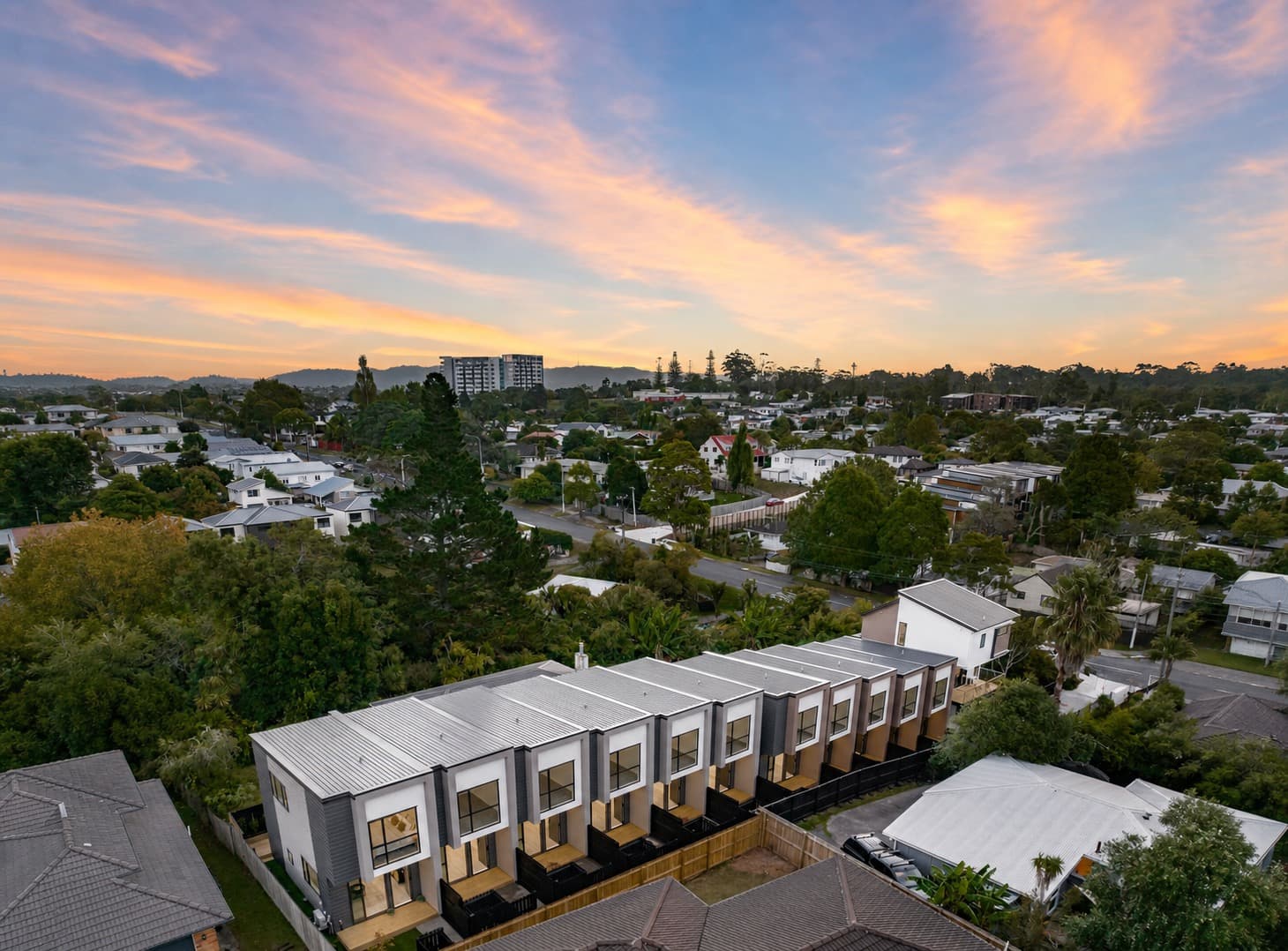 Completed townhouse development used to represent sale and delivery.