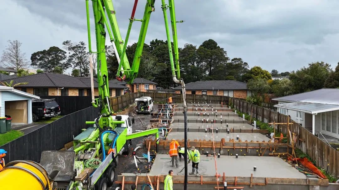 Concrete pour underway on an Auckland site, with the crew placing and levelling the slab.