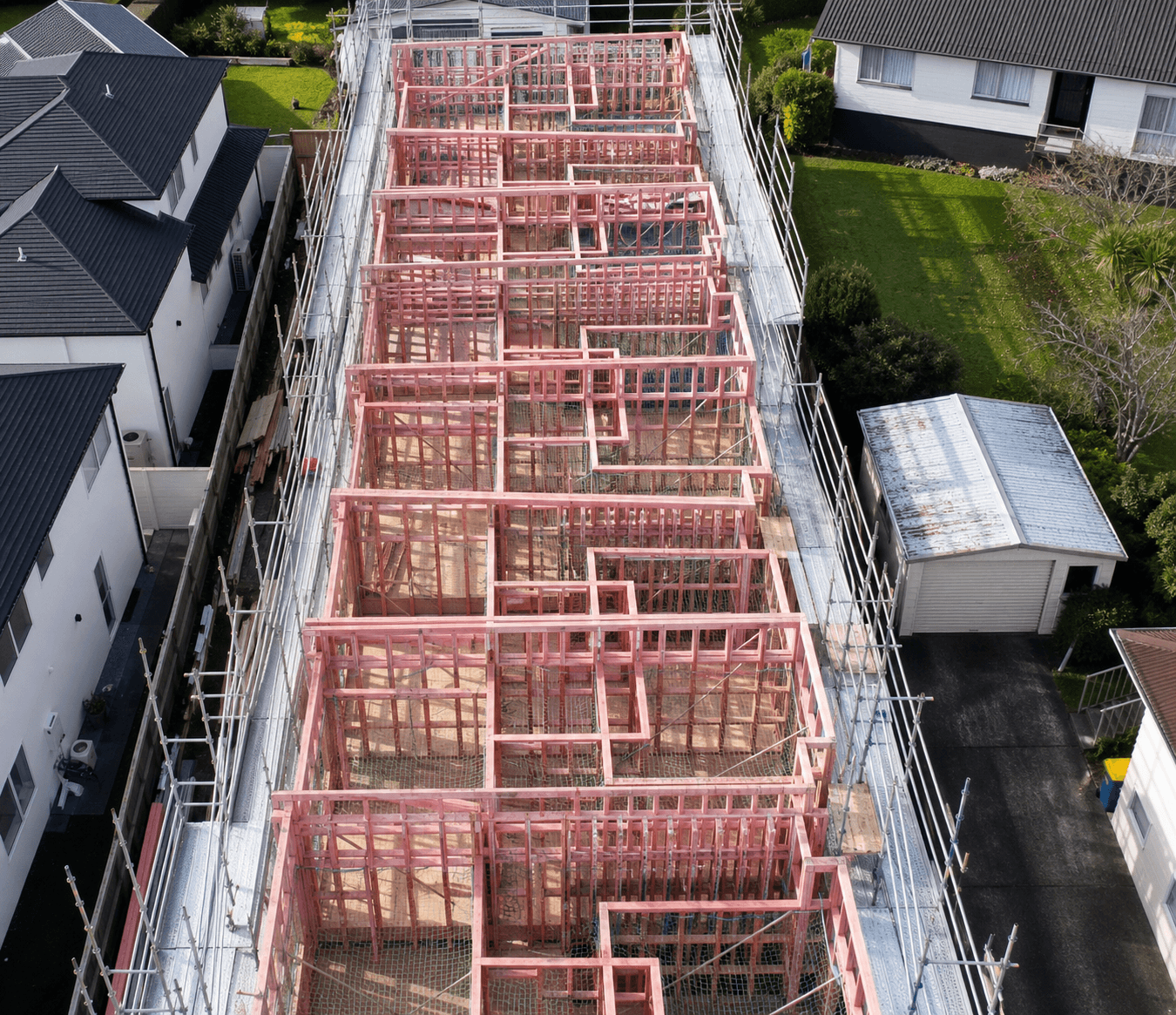 Aerial view of the Tudor Residences townhouse row mid-construction, framing complete